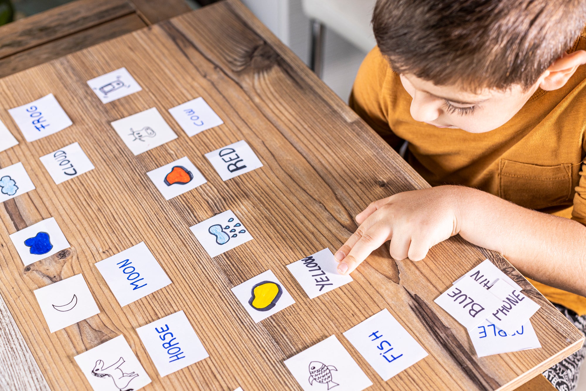 young student at desk with site word cards