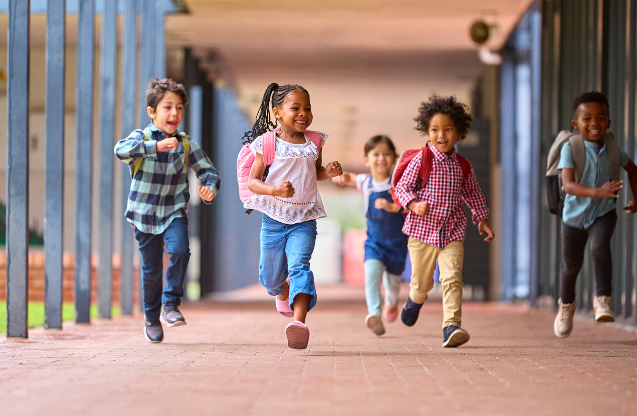 young students happily running and playing outside